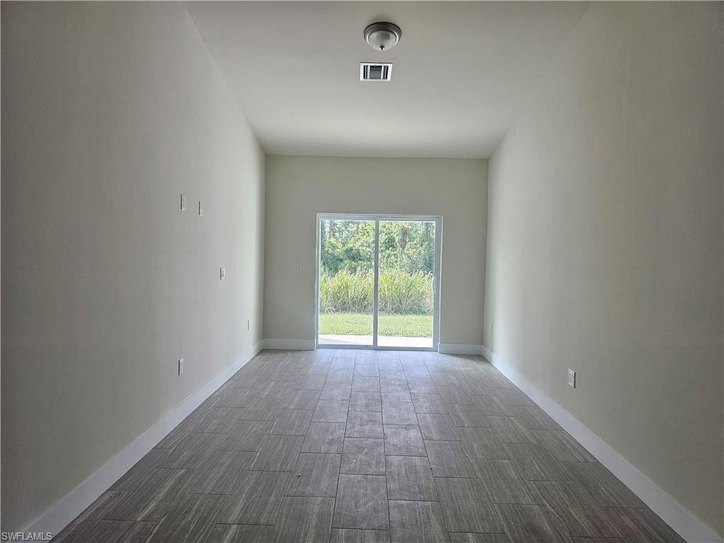 Spare room with wood tiled floors and baseboards