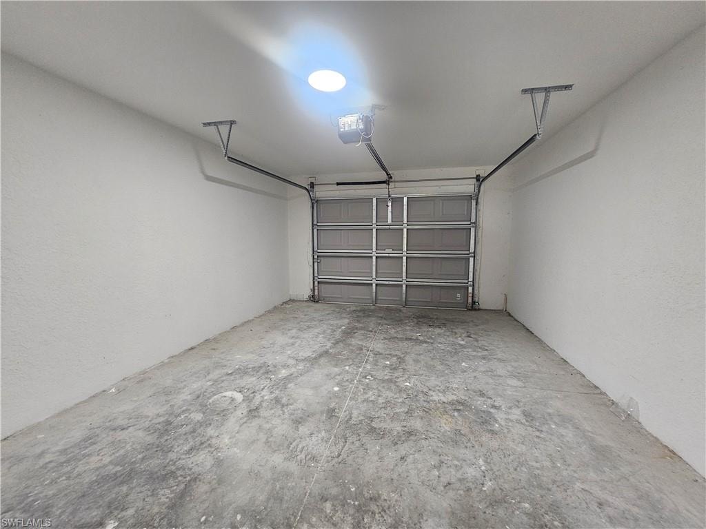 Garage featuring a garage door opener