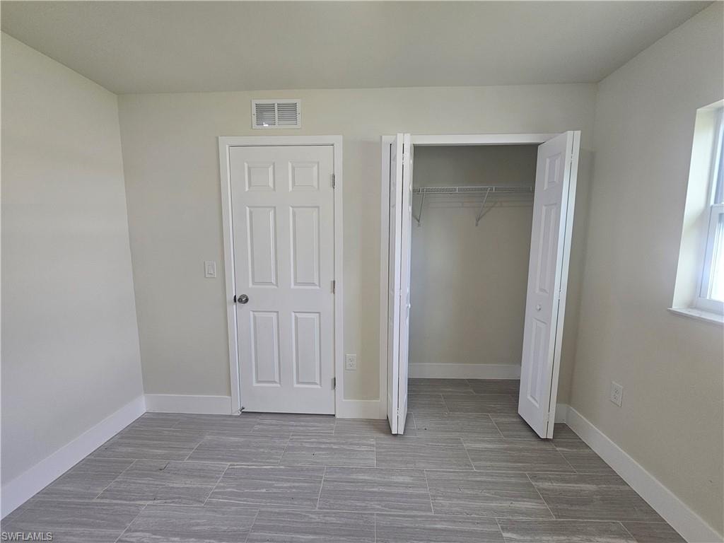 Unfurnished bedroom featuring baseboards and a closet