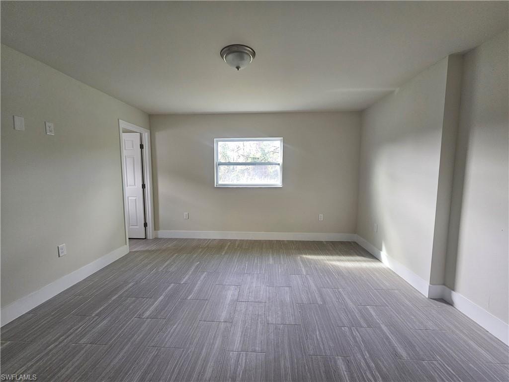 Empty room featuring light wood-style floors and baseboards