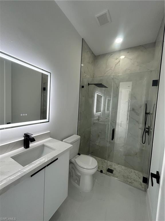 Bathroom with vanity and a marble finish shower