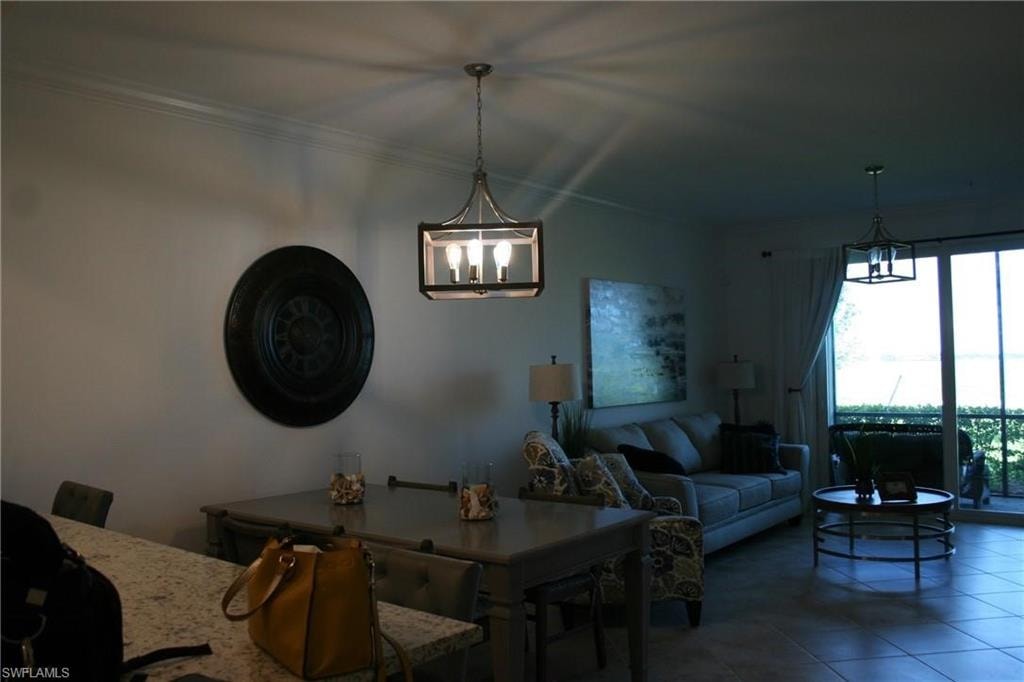 Dining space featuring a chandelier and dark tile patterned floors