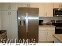 Kitchen featuring appliances with stainless steel finishes and light countertops