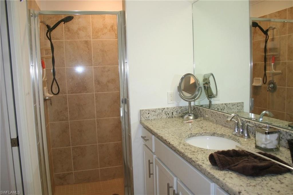 Bathroom with vanity and a stall shower