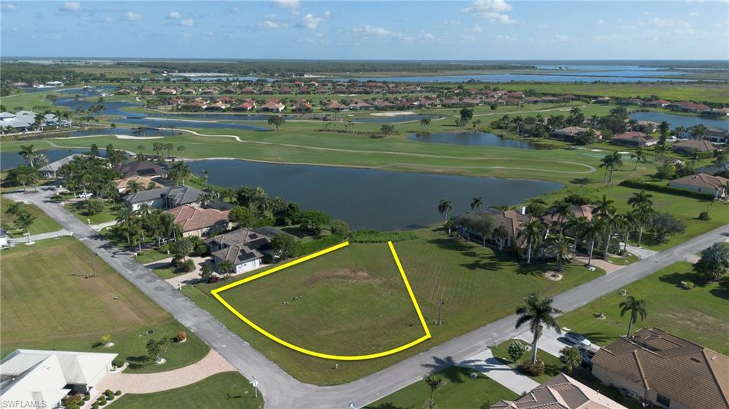 Aerial view of residential property boundaries highlighted, and overview of golf course and lake
