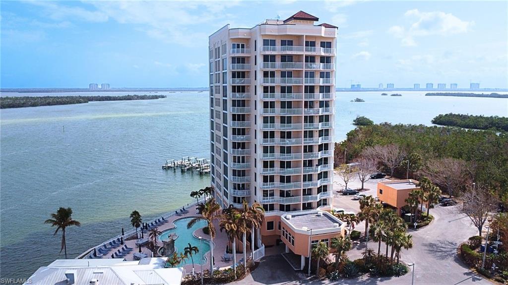 View of property with a water view and a community pool Virtually edited image