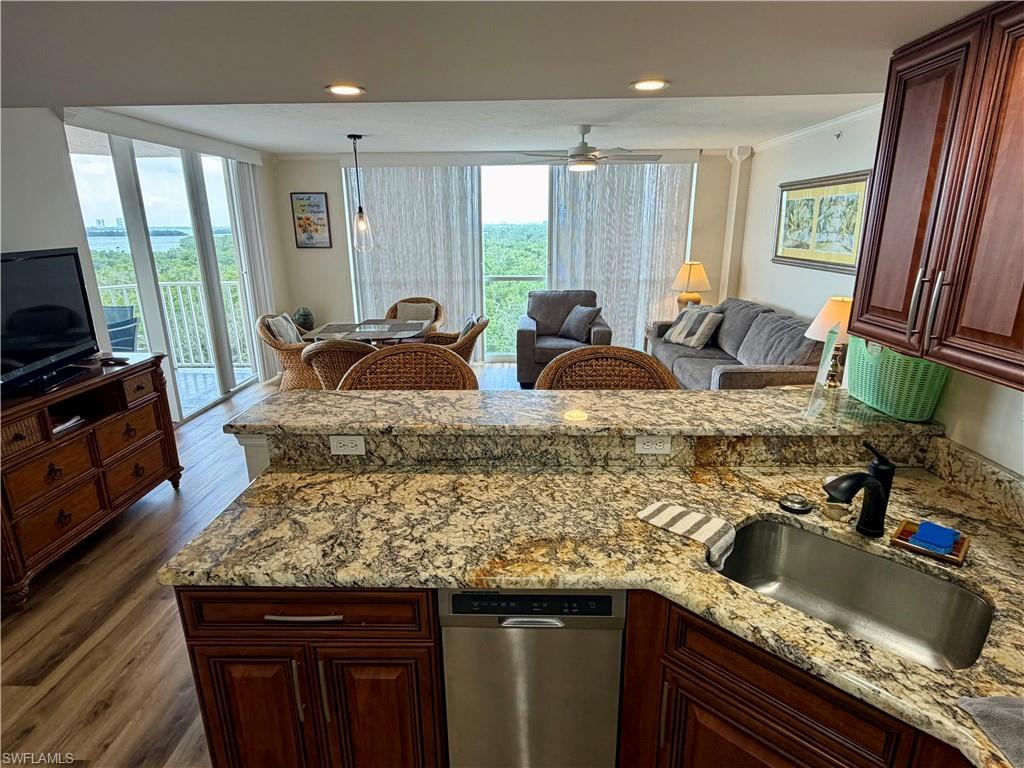 Kitchen counter featuring granite countertops with an undermount stainless steel sink and a matte black faucet