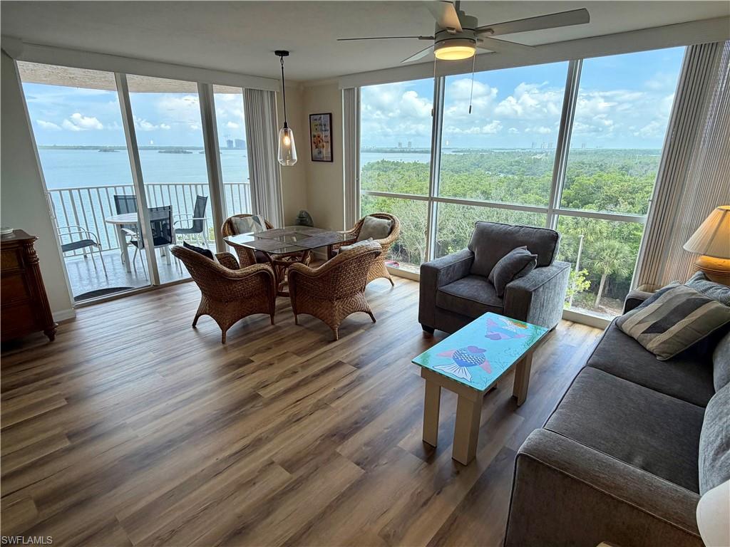 Expansive living area with wood-finish flooring and panoramic window walls