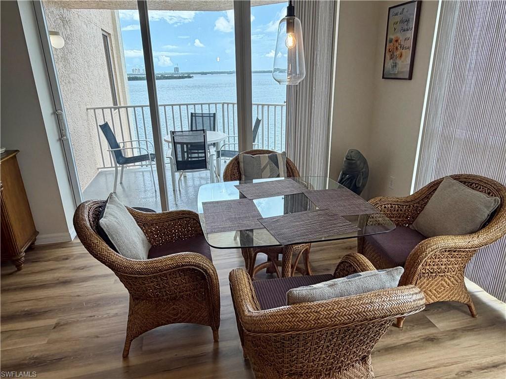Dining area featuring wood-finish flooring and direct access to a private balcony