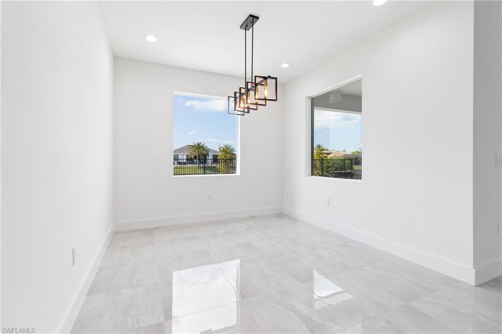 Empty room with baseboards and recessed lighting