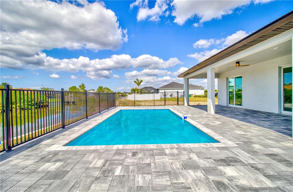 View of pool featuring a fenced backyard, a ceiling fan, a fenced in pool, and a patio