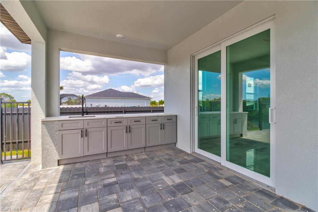 View of patio / terrace with a sink, fence, and area for grilling