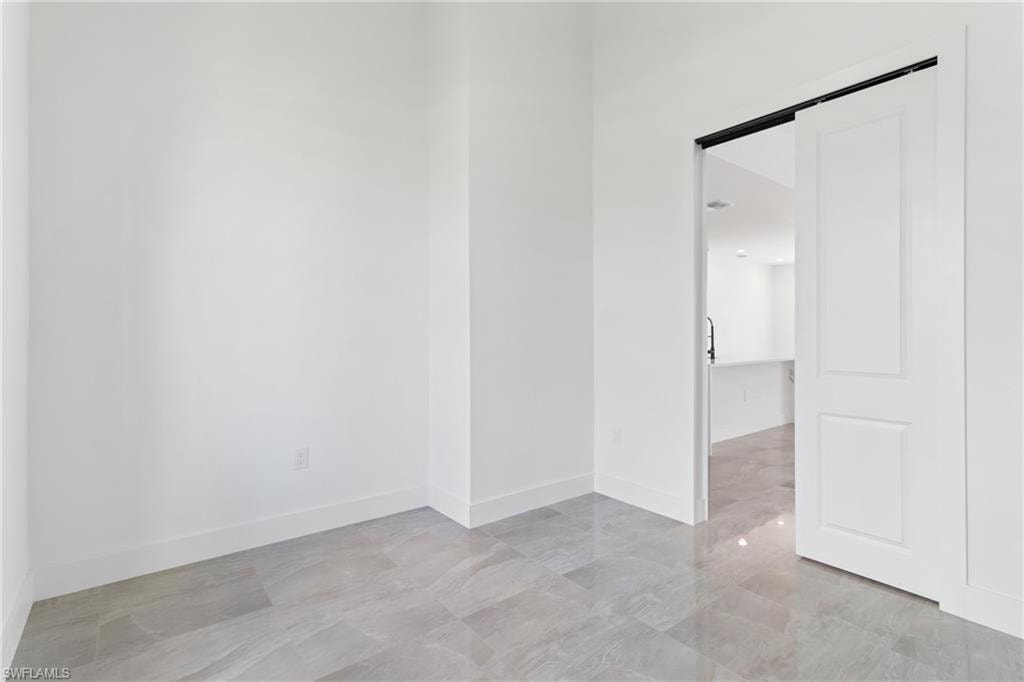 Empty room featuring baseboards