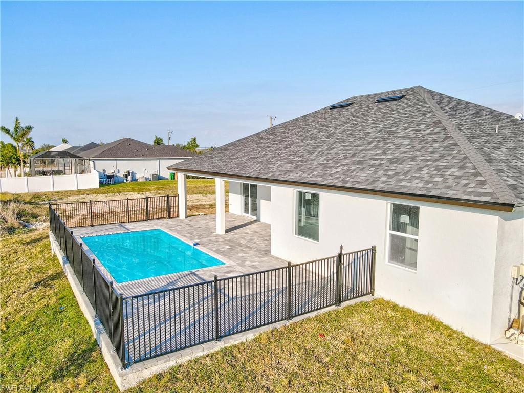 View of swimming pool with a patio, a fenced backyard, a fenced in pool, and a lawn