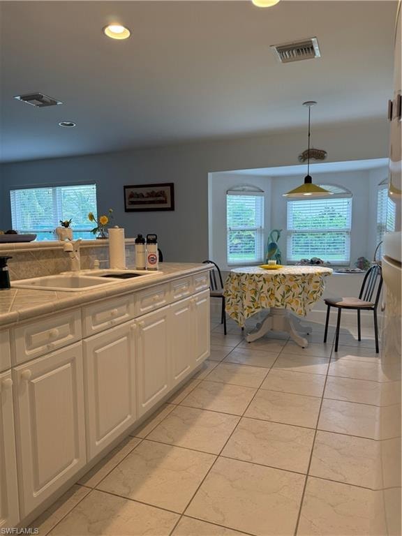 Living area featuring tile patterned floors and a chandelier