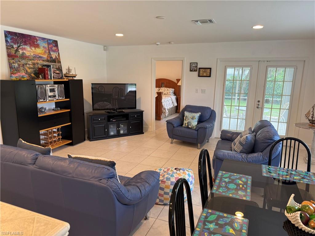 Bedroom with access to outside and light tile patterned floors