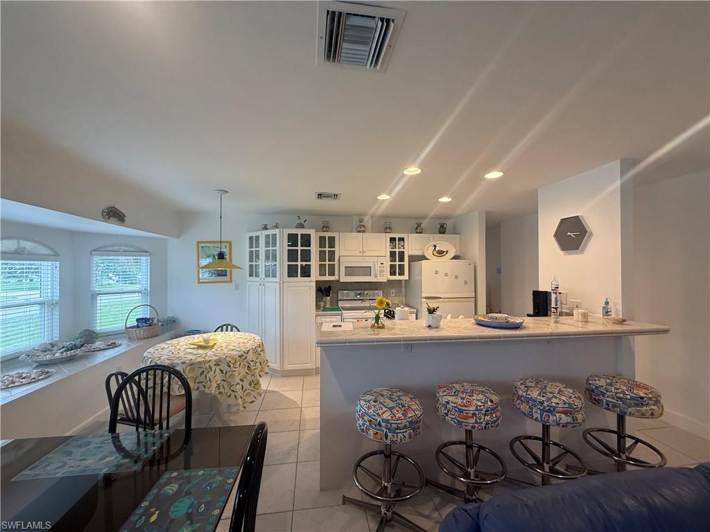 Dining room featuring french doors, recessed lighting, and light tile patterned floors