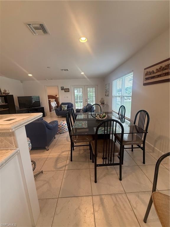 Dining space featuring plenty of natural light and recessed lighting