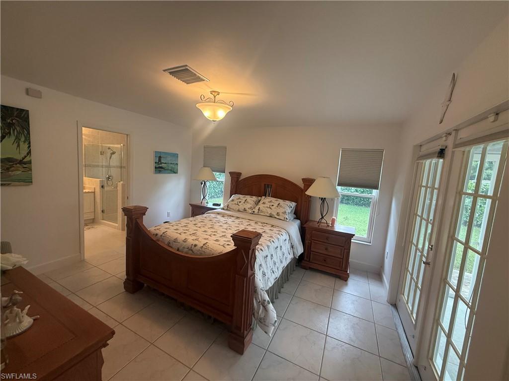 Living area with light tile patterned floors, recessed lighting, and french doors