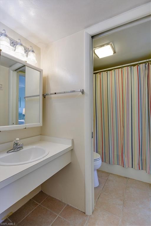 Bathroom featuring light tile patterned floors and vanity