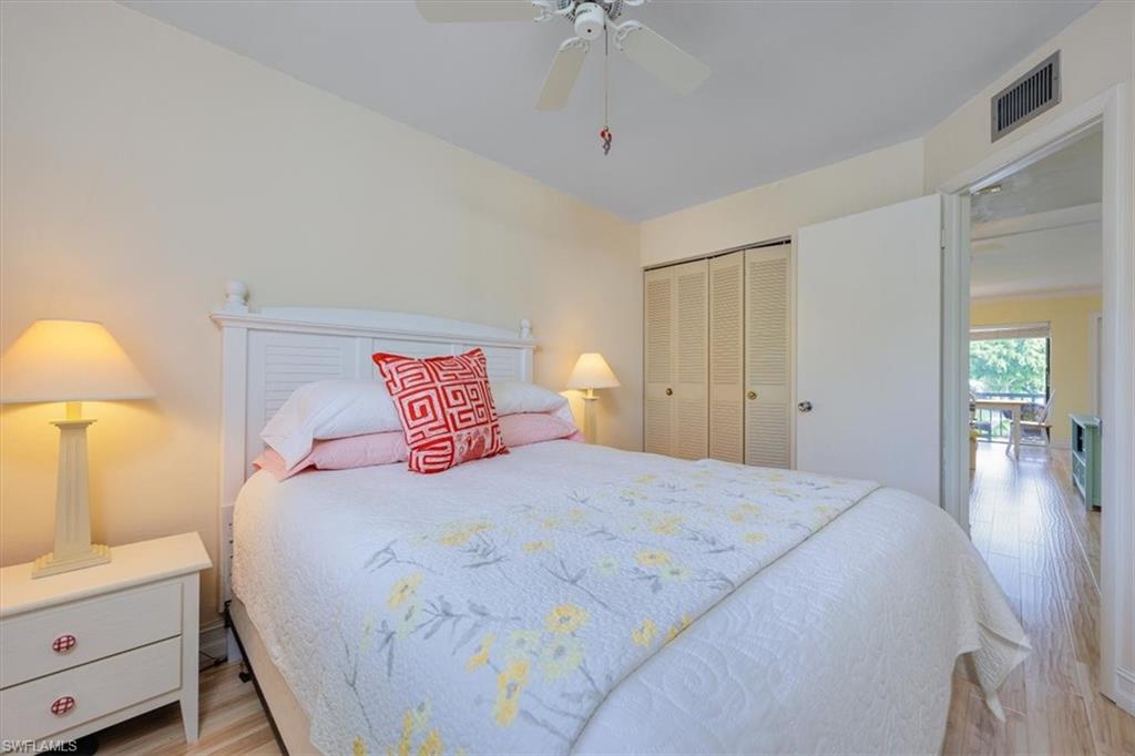 Bedroom with light wood-style floors, a closet, and ceiling fan