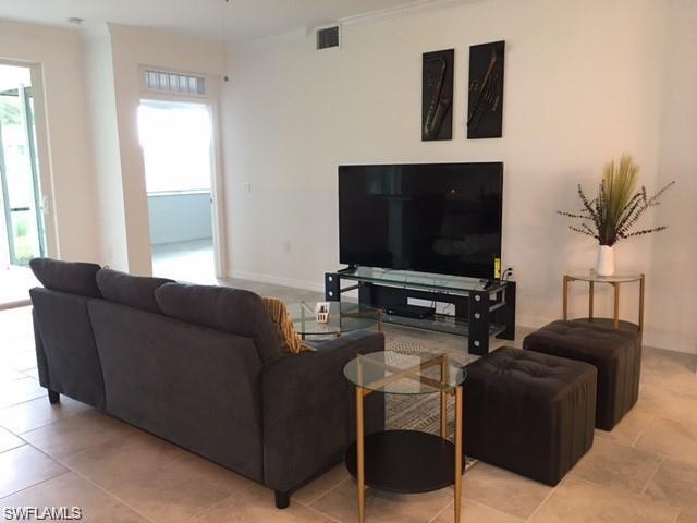 Living room featuring a healthy amount of sunlight and light tile patterned floors