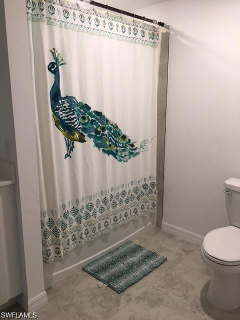 Bathroom with tile patterned floors and toilet