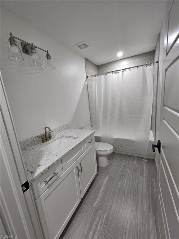 Full bathroom with shower / tub combo and vanity