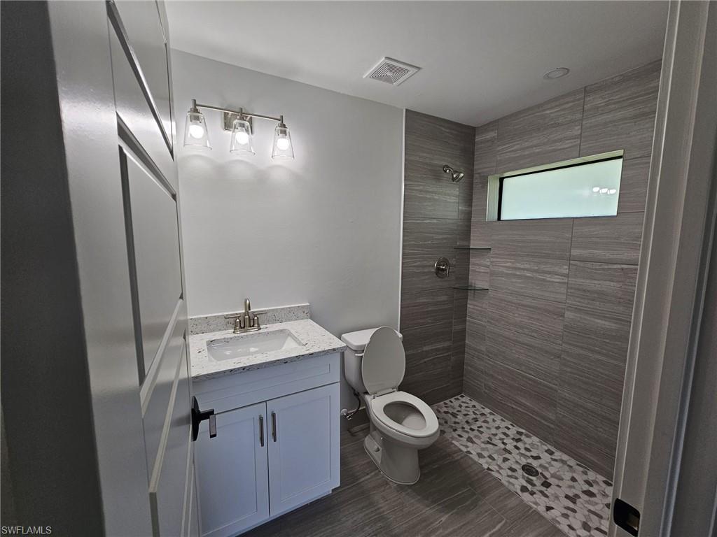 Bathroom featuring vanity and a stall shower