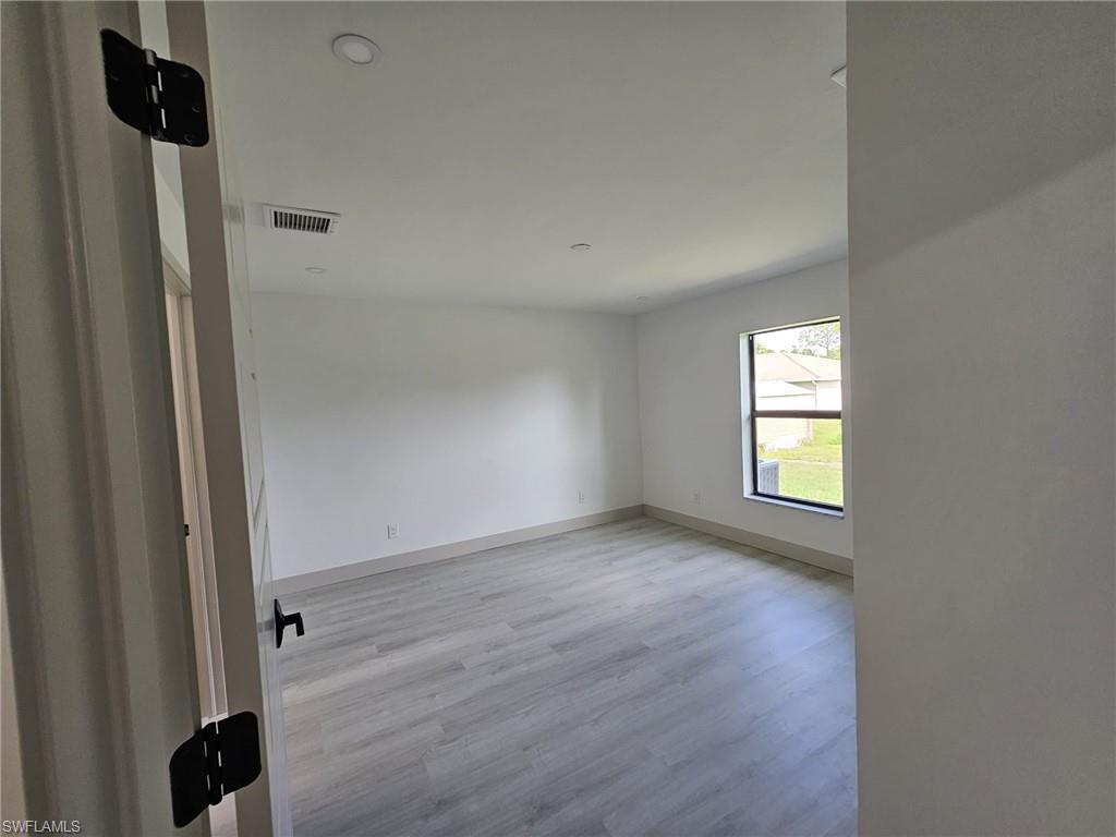 Spare room featuring light wood-style flooring and recessed lighting