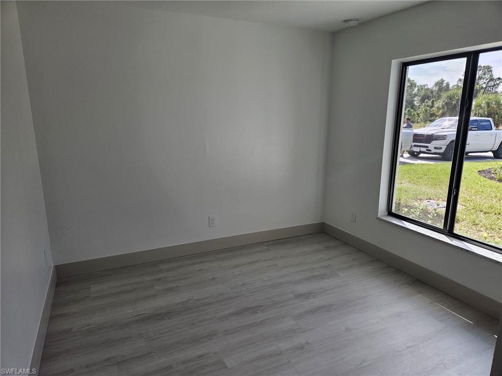 Empty room with light wood finished floors