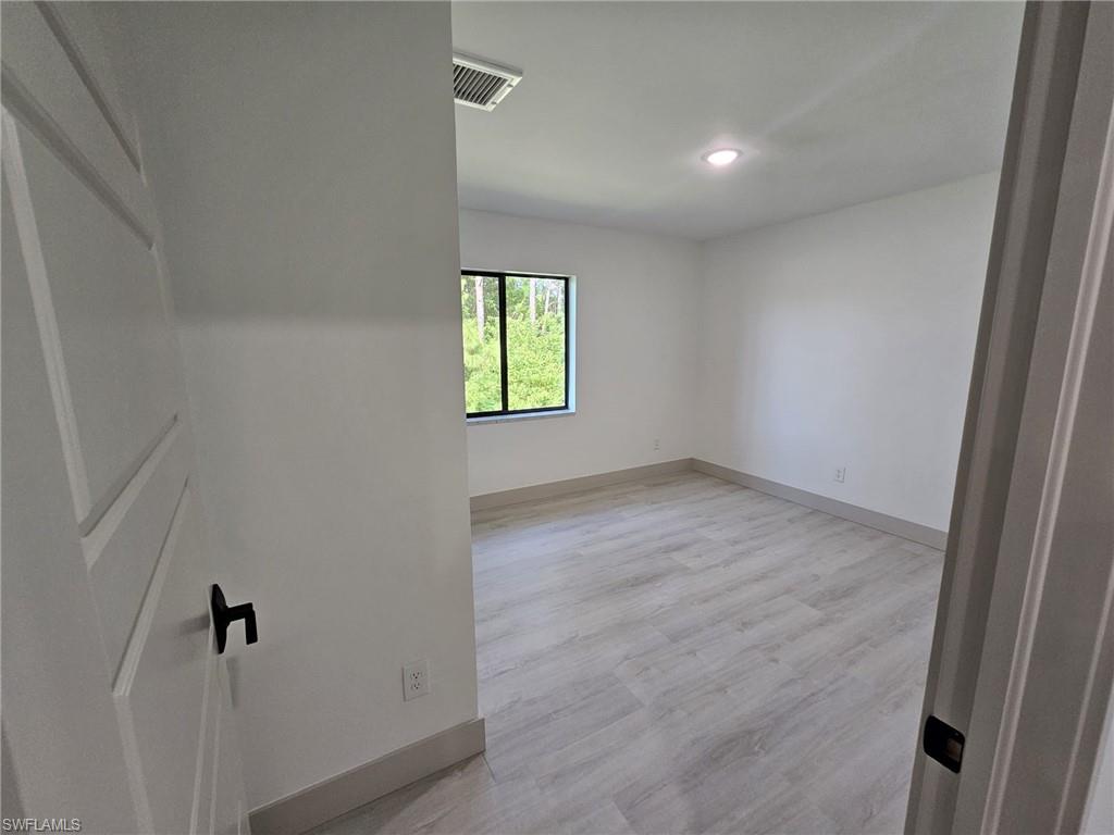 Unfurnished room featuring light wood-style flooring and recessed lighting