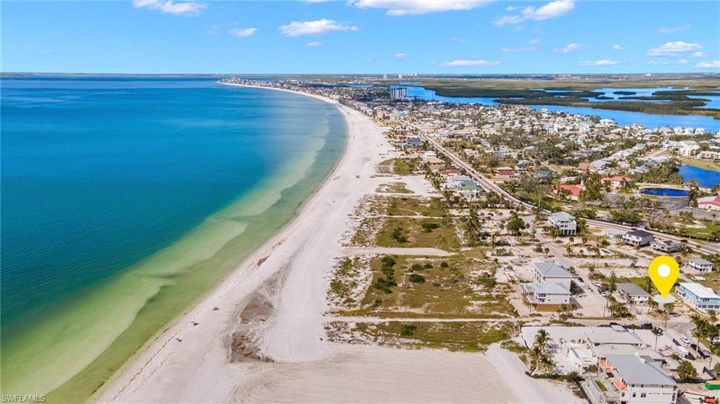 Aerial view featuring a beach view and a water viewVirtually enhanced