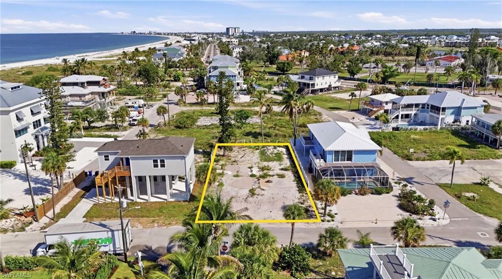Vacant lot featuring existing vegetation and surrounding residential properties. virtually enhanced