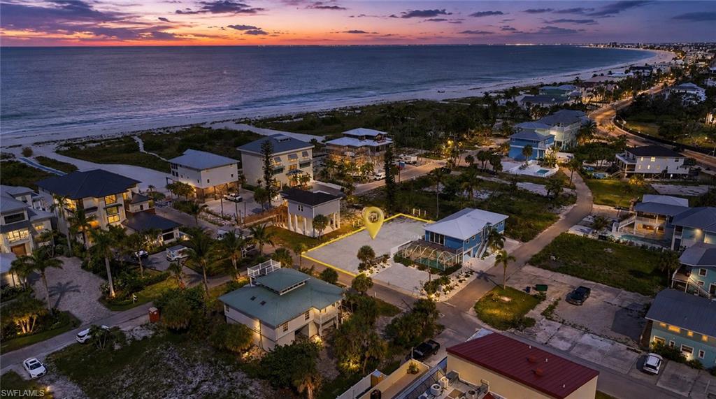 Expansive beachfront property featuring a coastal setting with sand and Gulf. virtually enhanced