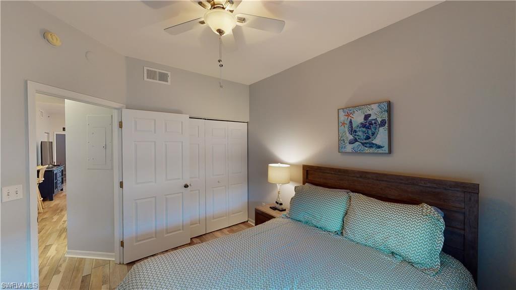 Bedroom featuring wood finished floors, a closet, and ceiling fan
