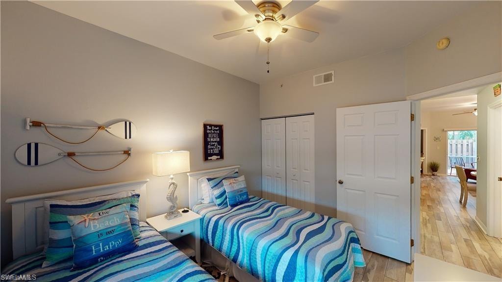Bedroom featuring a closet, light wood-type flooring, and ceiling fan