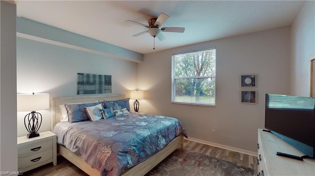 Bedroom with wood finished floors and a ceiling fan
