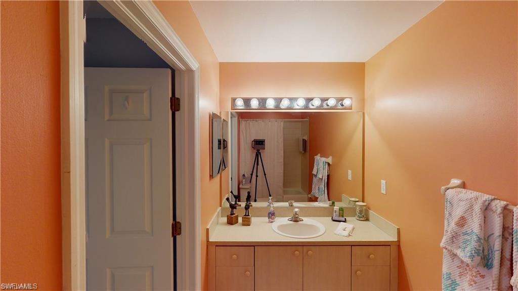 Bathroom with vanity and shower / bath combination with curtain