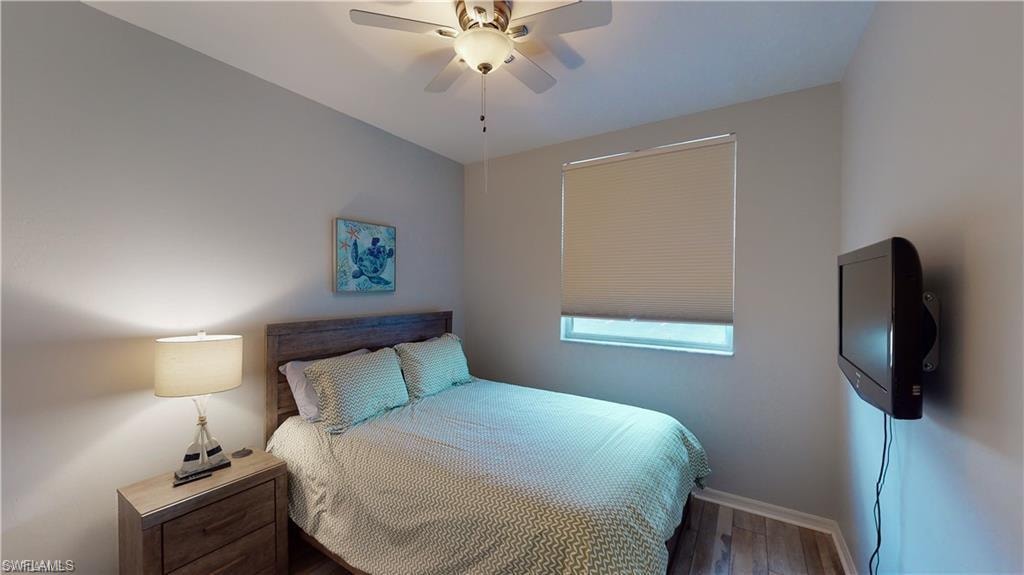 Bedroom featuring wood finished floors and a ceiling fan