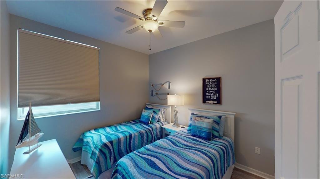 Bedroom featuring ceiling fan and wood finished floors