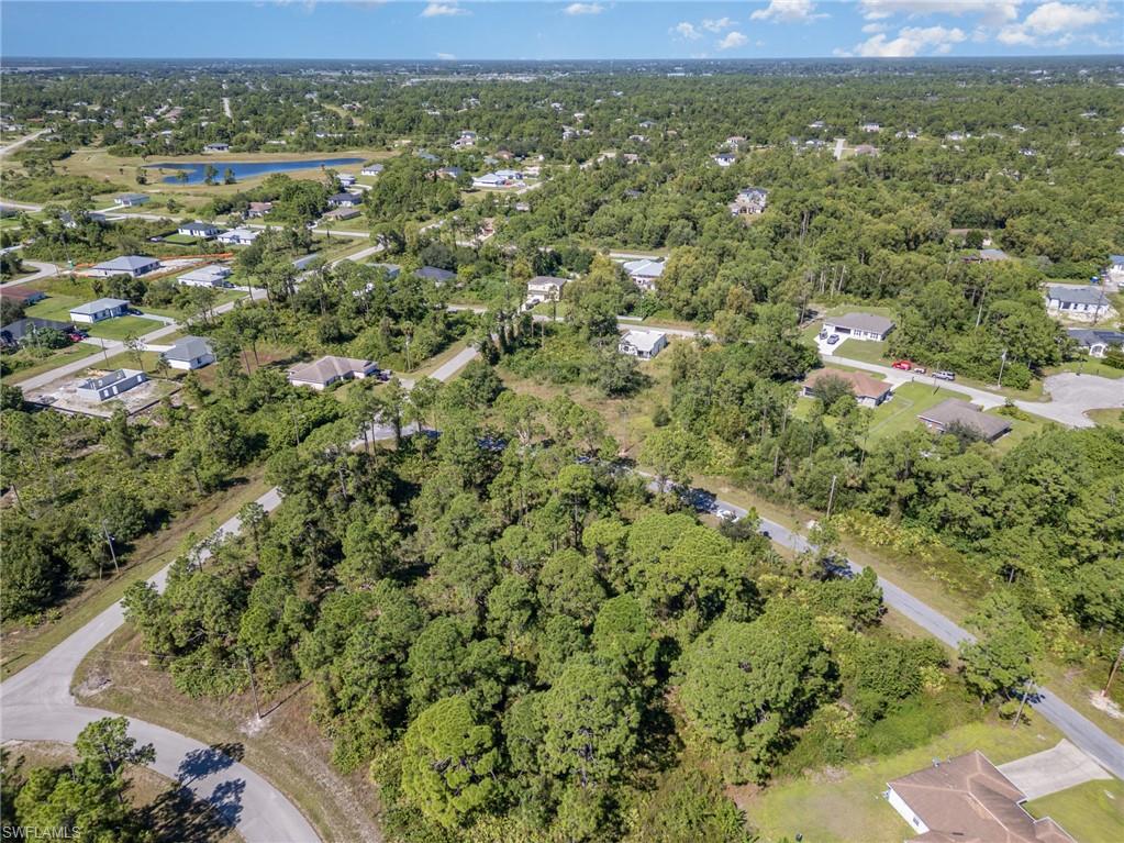 Aerial view of property's location with nearby suburban area and a large body of water
