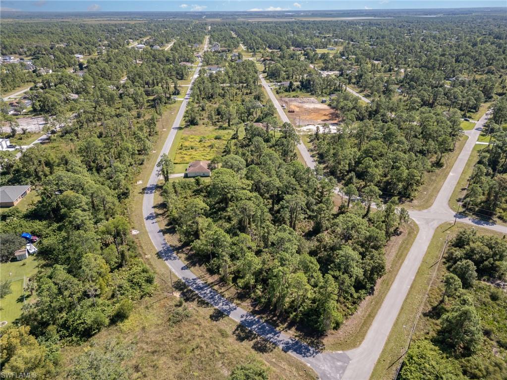 Aerial view of property's location featuring a forest