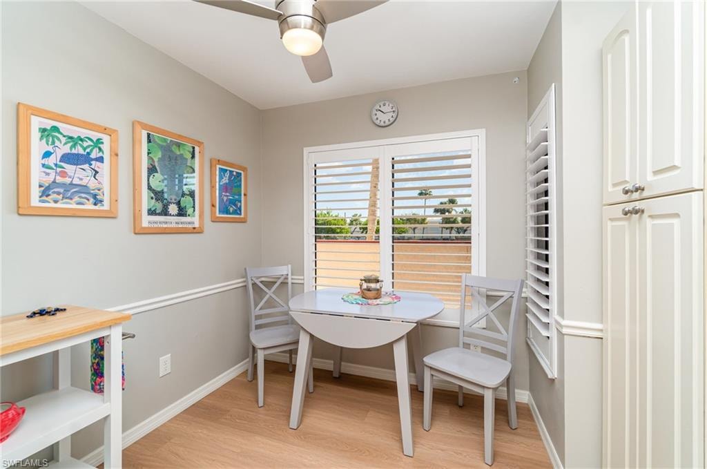 Breakfast area featuring plantation shutters and a ceiling fan