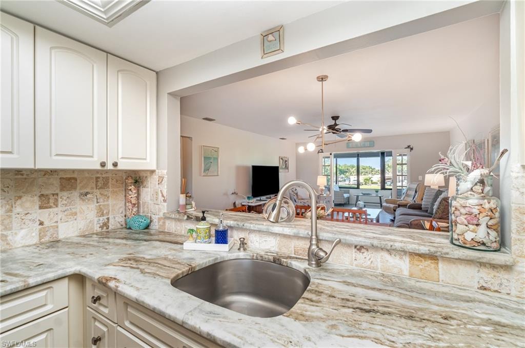 Kitchen features a pass-through window to dining area