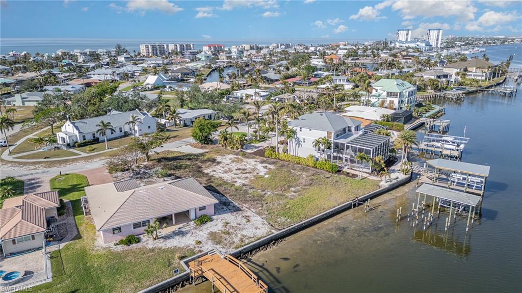 Aerial perspective of suburban area featuring a nearby body of water