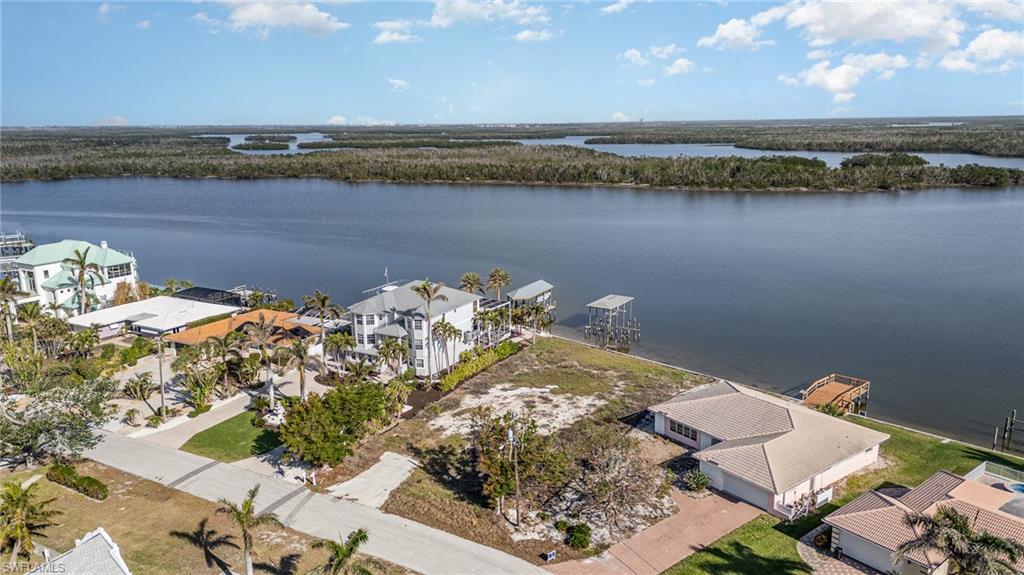 Aerial view of lot and surrounding properties