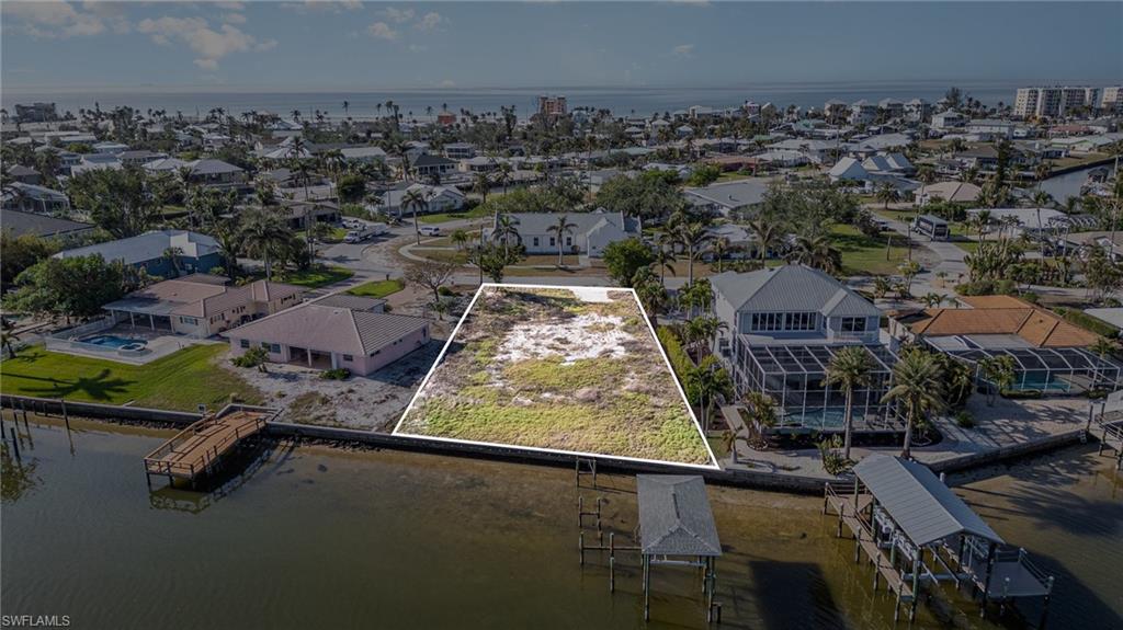 Spectacular oversized buildable Bayfront lot at just over a third of an acre on Estero Bay Estuary and close to the sparkling gulf waters and sugary white sand of Fort Myers Beach!