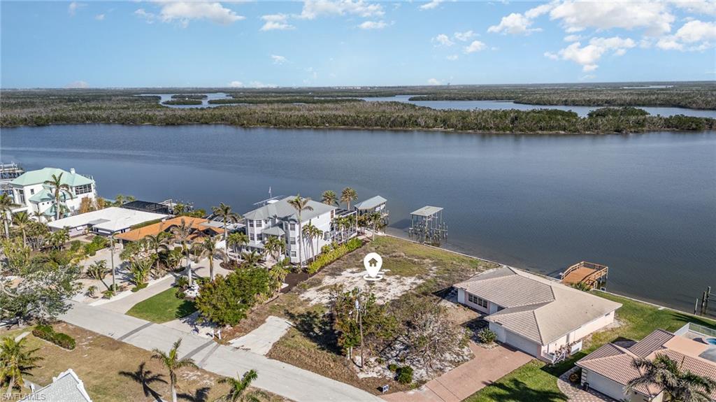 Aerial view of residential area featuring a nearby body of water