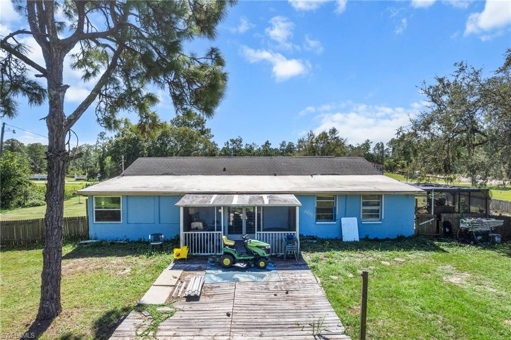 Rear view of house with a sunroom